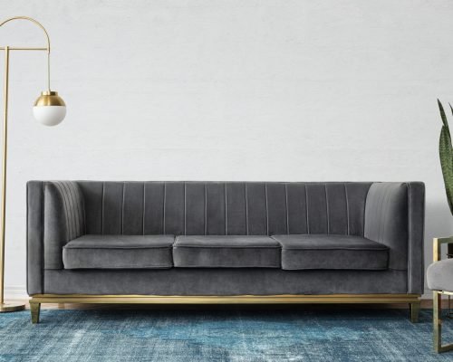 Chic mid-century modern luxury aesthetics living room with gray velvet couch and blue rug