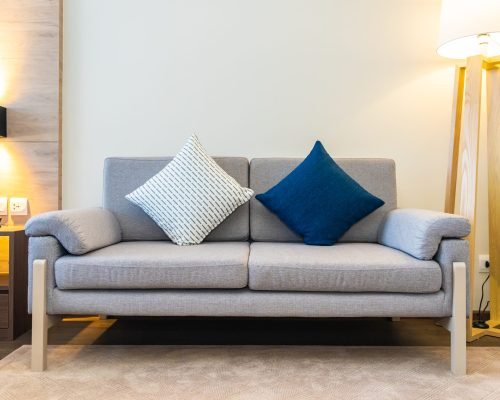 Comfortable pillow on sofa decoration with light lamp interior of living room area